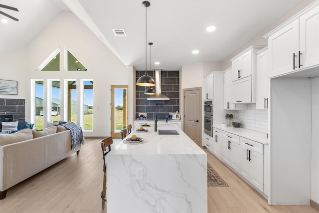 1561 Dixie Estates Way, Whitesboro, TX 76273 - kitchen featuring a sink, stainless steel double oven, light wood-style floors, tasteful backsplash, and recessed lighting