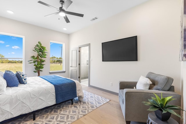 1561 Dixie Estates Way, Whitesboro, TX 76273 - bedroom featuring multiple windows, light wood-style flooring, ensuite bath, recessed lighting, and baseboards