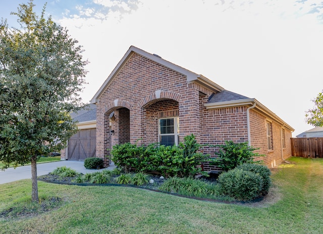 view of front of property with a front lawn and a garage