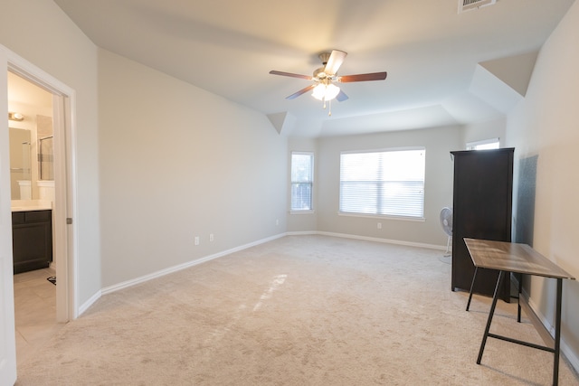 interior space with lofted ceiling, light colored carpet, and ceiling fan