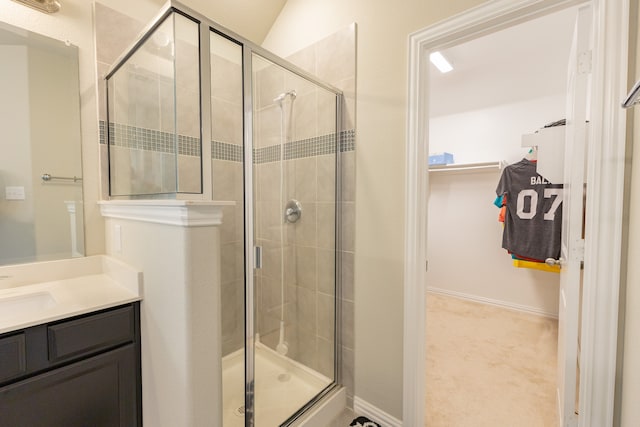 bathroom with vanity, lofted ceiling, and a shower with shower door