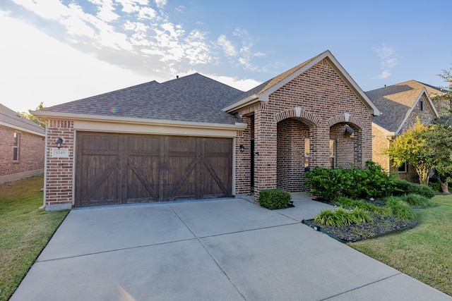 view of front of home with a front lawn and a garage