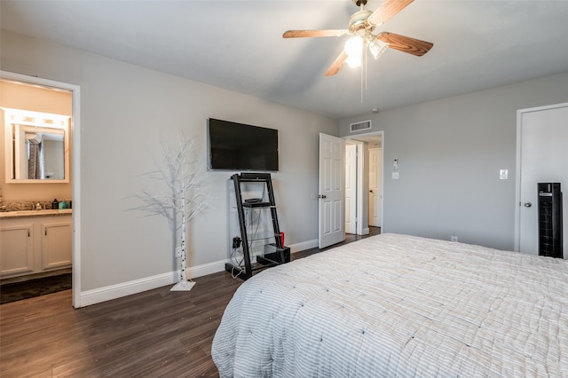 bedroom with dark hardwood / wood-style floors, ensuite bathroom, and ceiling fan