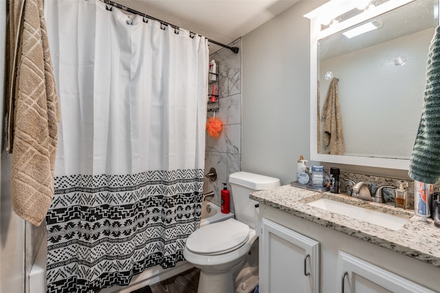 full bathroom with vanity, shower / bath combo, and toilet