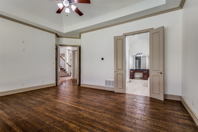 unfurnished room with lofted ceiling, crown molding, ceiling fan, and dark hardwood / wood-style flooring