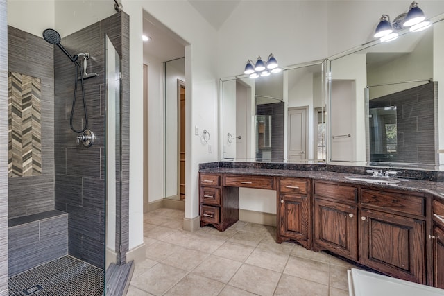 bathroom featuring vanity, tiled shower, and tile patterned floors