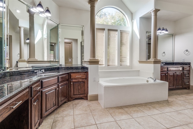 bathroom with vanity, tile patterned floors, a bath, and vaulted ceiling