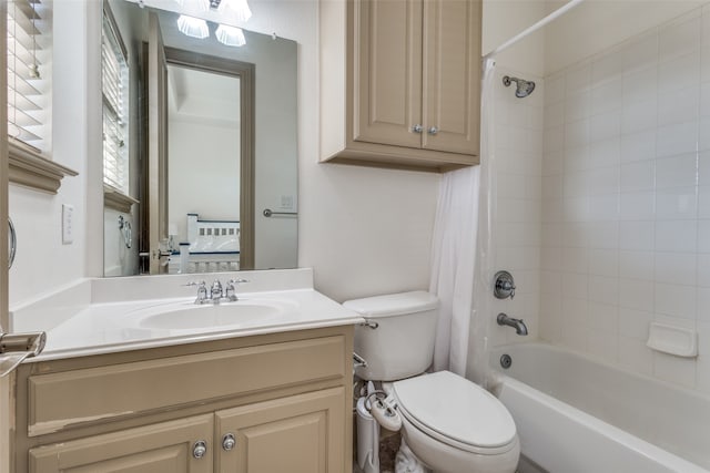 full bathroom with toilet, shower / bath combo with shower curtain, and vanity