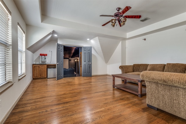 living room with ceiling fan and dark hardwood / wood-style floors