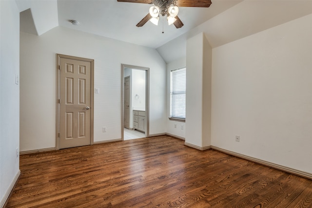 unfurnished bedroom with ensuite bathroom, hardwood / wood-style floors, ceiling fan, and vaulted ceiling