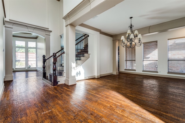 interior space featuring crown molding, a notable chandelier, and dark hardwood / wood-style flooring