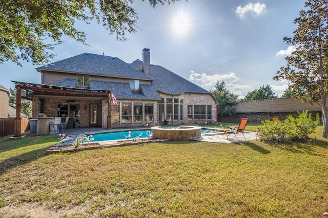 back of property featuring a yard, a patio area, and a pool with hot tub