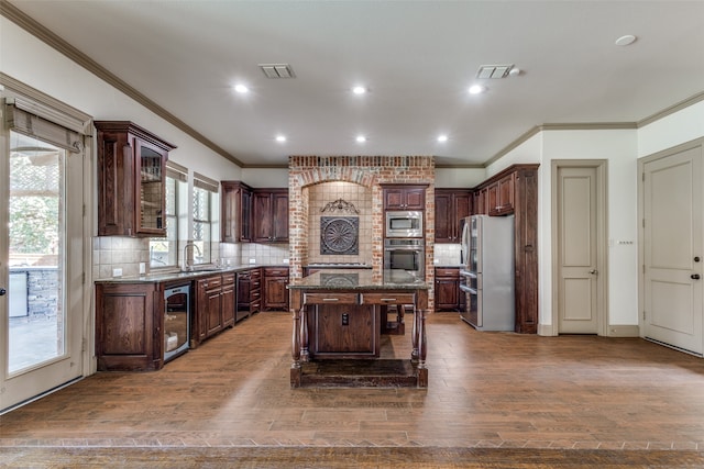 kitchen featuring a kitchen island, backsplash, dark hardwood / wood-style flooring, stainless steel appliances, and wine cooler