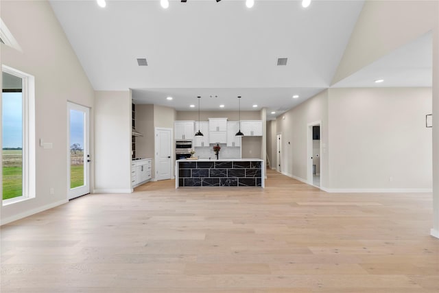 1230 Dixie Estates Way, Whitesboro, TX 76273 - unfurnished living room featuring light wood finished floors, high vaulted ceiling, recessed lighting, and baseboards