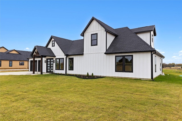 1230 Dixie Estates Way, Whitesboro, TX 76273 - back of property with board and batten siding, a shingled roof, a garage, and a yard