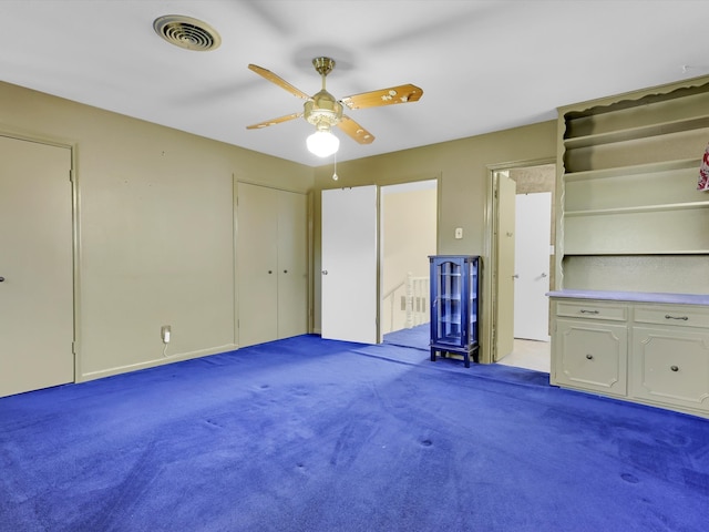 unfurnished bedroom with light colored carpet and ceiling fan