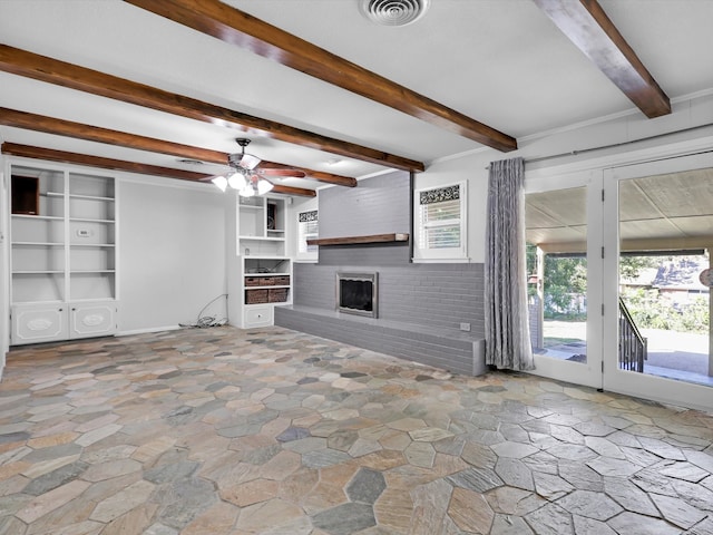 unfurnished living room featuring beam ceiling, a fireplace, and ceiling fan