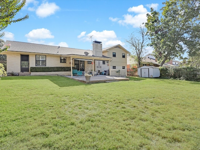 back of property with a shed, a patio area, and a lawn