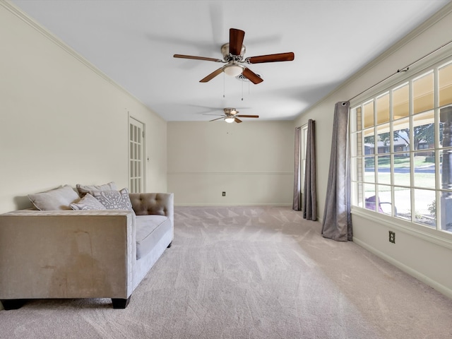 unfurnished room featuring light carpet, crown molding, and ceiling fan