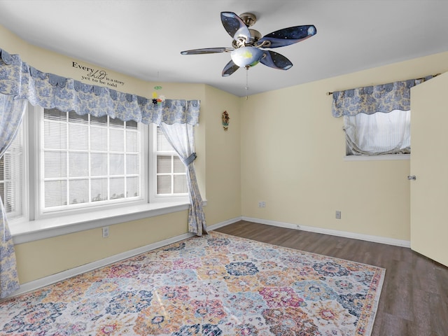 spare room with ceiling fan and dark hardwood / wood-style flooring