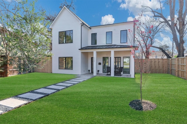 modern inspired farmhouse featuring a garage and a front lawn