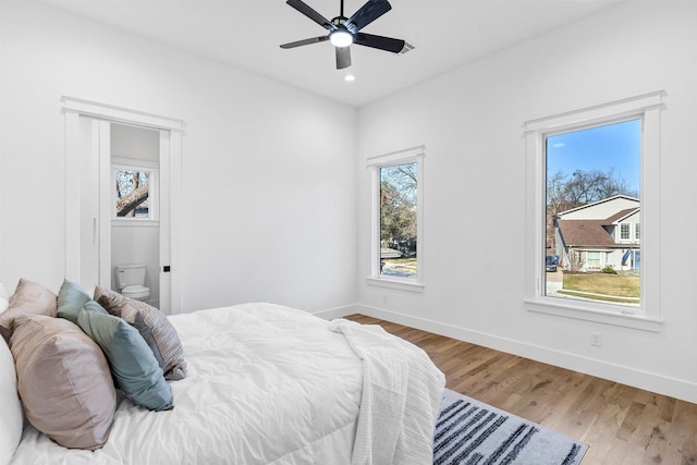 bedroom featuring hardwood / wood-style flooring, ceiling fan, and ensuite bathroom