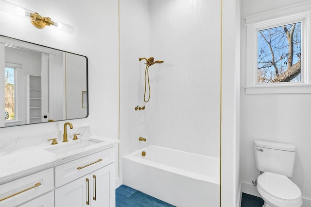 full bathroom featuring vanity, bathtub / shower combination, and toilet