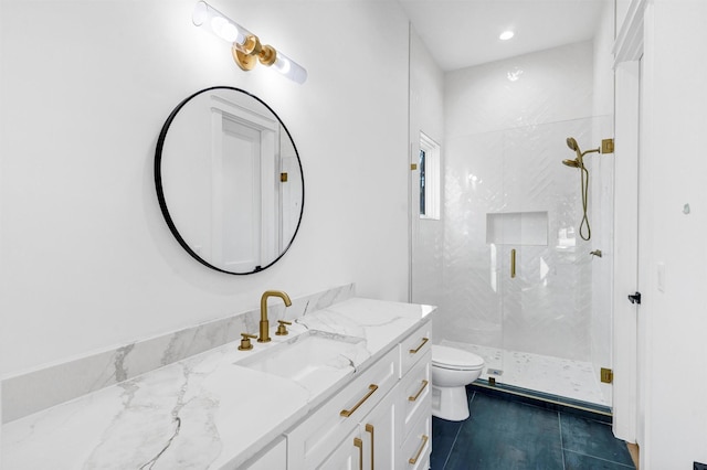 bathroom featuring toilet, vanity, and walk in shower