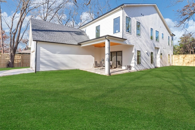 back of house featuring a lawn and a patio