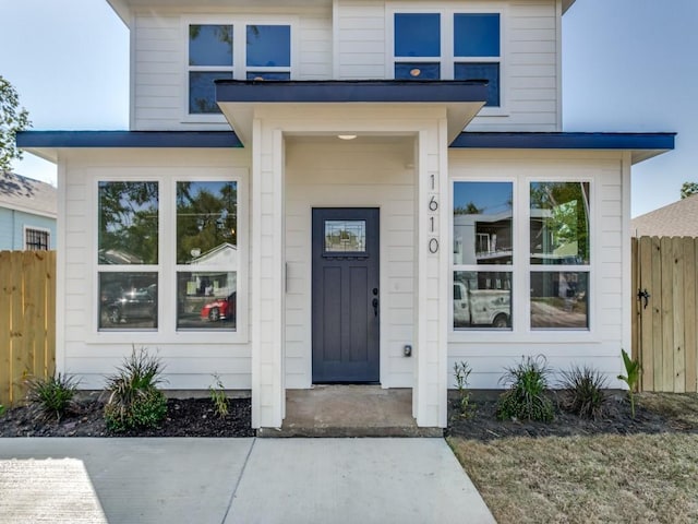 doorway to property featuring fence