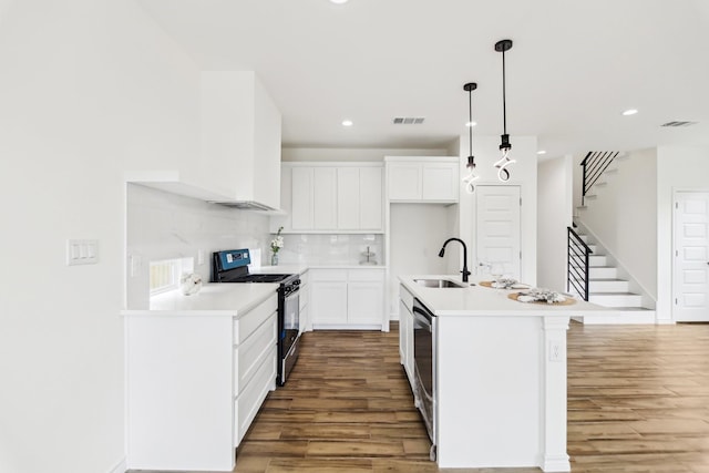 1610 Life Ave, Dallas, TX 75212 - kitchen featuring range with gas stovetop, a sink, light wood finished floors, recessed lighting, and backsplash