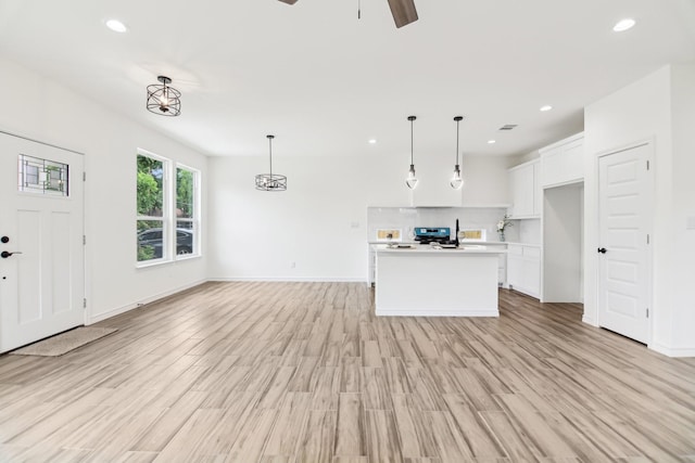 1610 Life Ave, Dallas, TX 75212 - unfurnished living room featuring ceiling fan, recessed lighting, light wood-style flooring, and baseboards