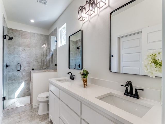 bathroom with vanity, toilet, tile patterned floors, and a shower with door