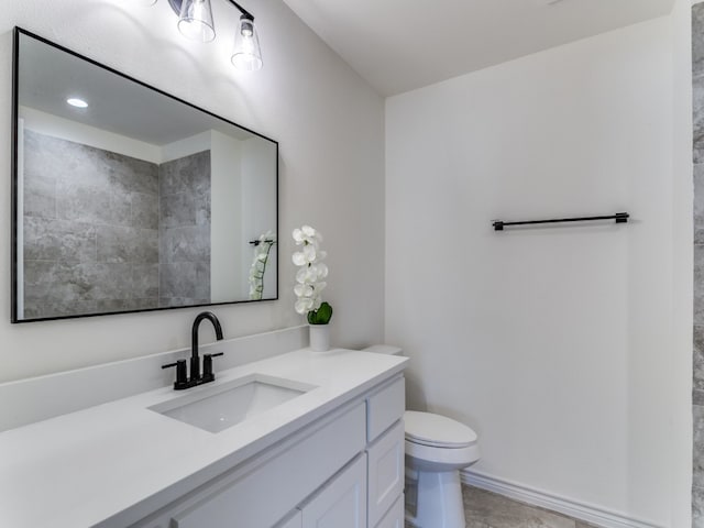 bathroom featuring vanity, toilet, and tile patterned flooring