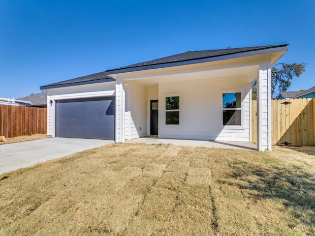 view of front of house with a front yard and a garage