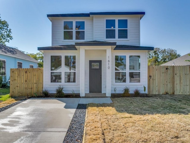 view of front facade with a front yard and fence