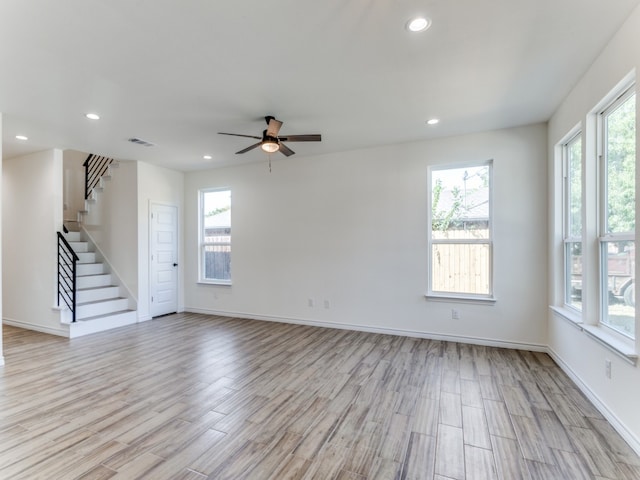 unfurnished room with ceiling fan, a healthy amount of sunlight, and light hardwood / wood-style flooring