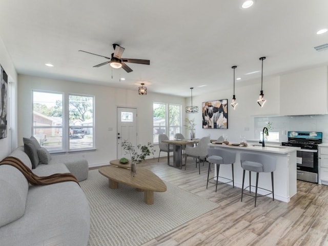 1610 Life Ave, Dallas, TX 75212 - living room with recessed lighting, light wood-style floors, a ceiling fan, and baseboards