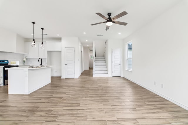 1610 Life Ave, Dallas, TX 75212 - kitchen with electric stove, open floor plan, a ceiling fan, recessed lighting, and light wood-type flooring