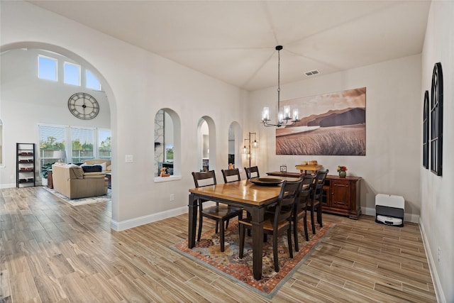 dining room featuring a chandelier, wood-type flooring, and a wealth of natural light