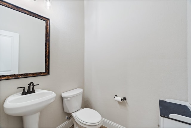 bathroom featuring toilet and sink