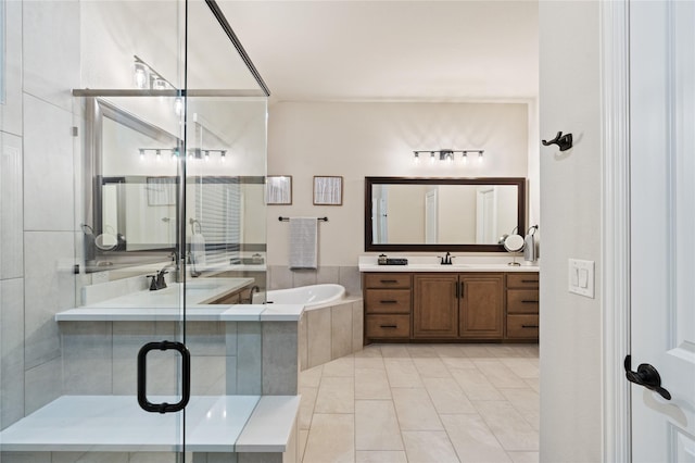 bathroom with tile patterned floors, vanity, and separate shower and tub