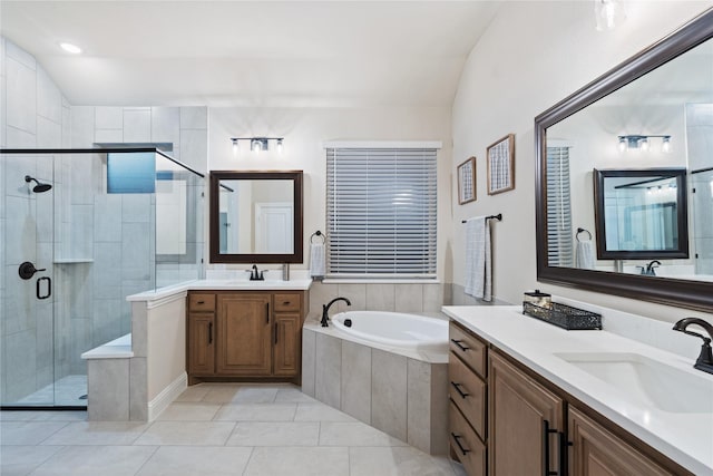 bathroom with tile patterned flooring, vanity, lofted ceiling, and shower with separate bathtub