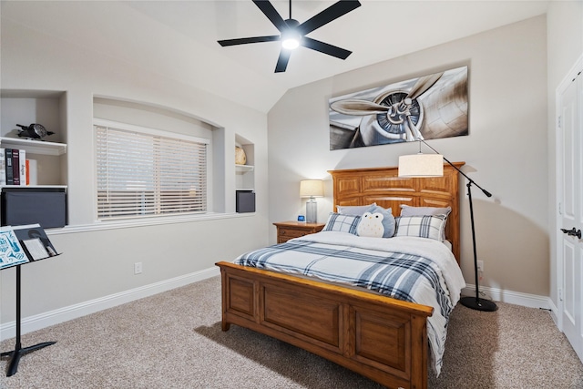 bedroom with ceiling fan, light colored carpet, and vaulted ceiling