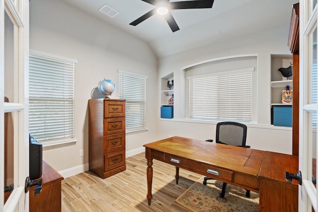 home office featuring plenty of natural light, light hardwood / wood-style flooring, and vaulted ceiling