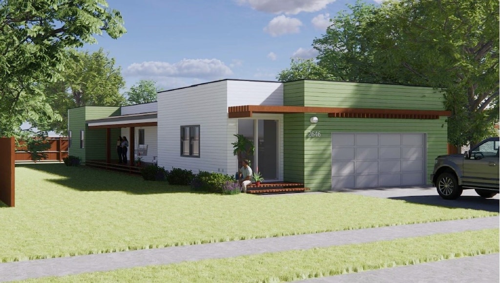 view of front of home featuring a front lawn and a garage