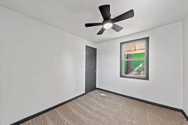 empty room featuring carpet floors and ceiling fan