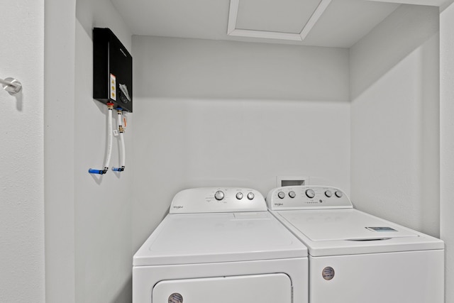 clothes washing area with washing machine and clothes dryer