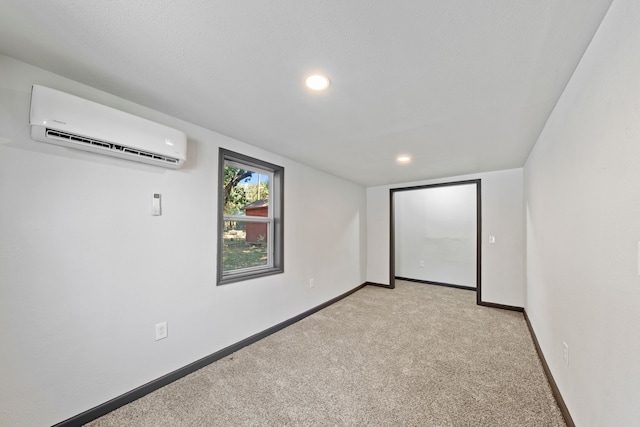 interior space with light colored carpet and a wall unit AC