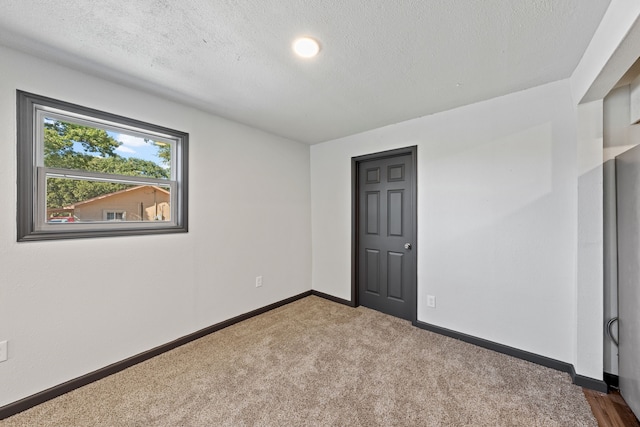 unfurnished bedroom featuring carpet floors and a textured ceiling